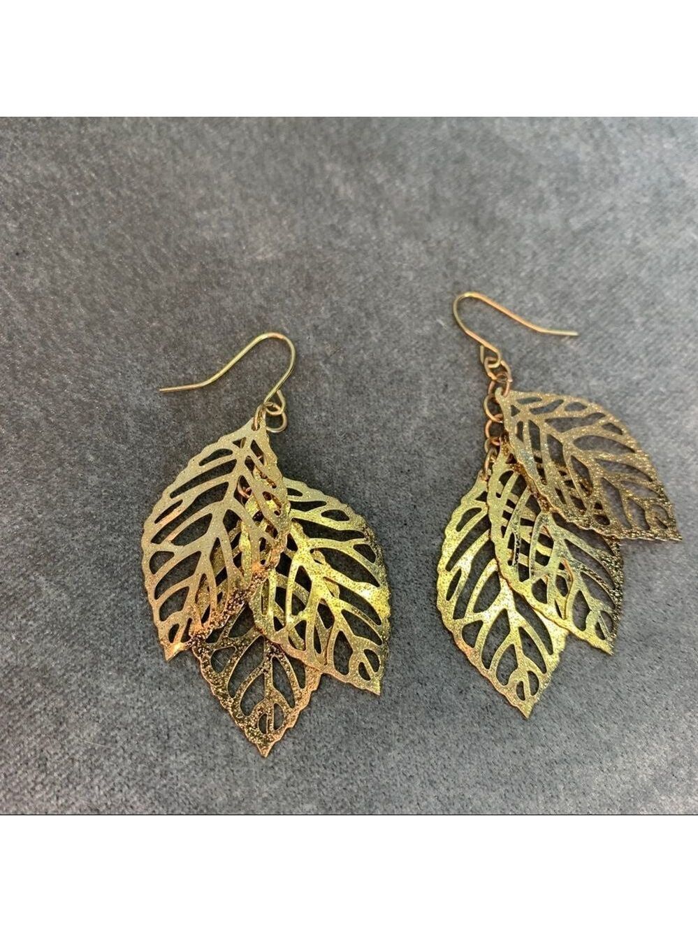 Gold tone three dangling leaf earrings